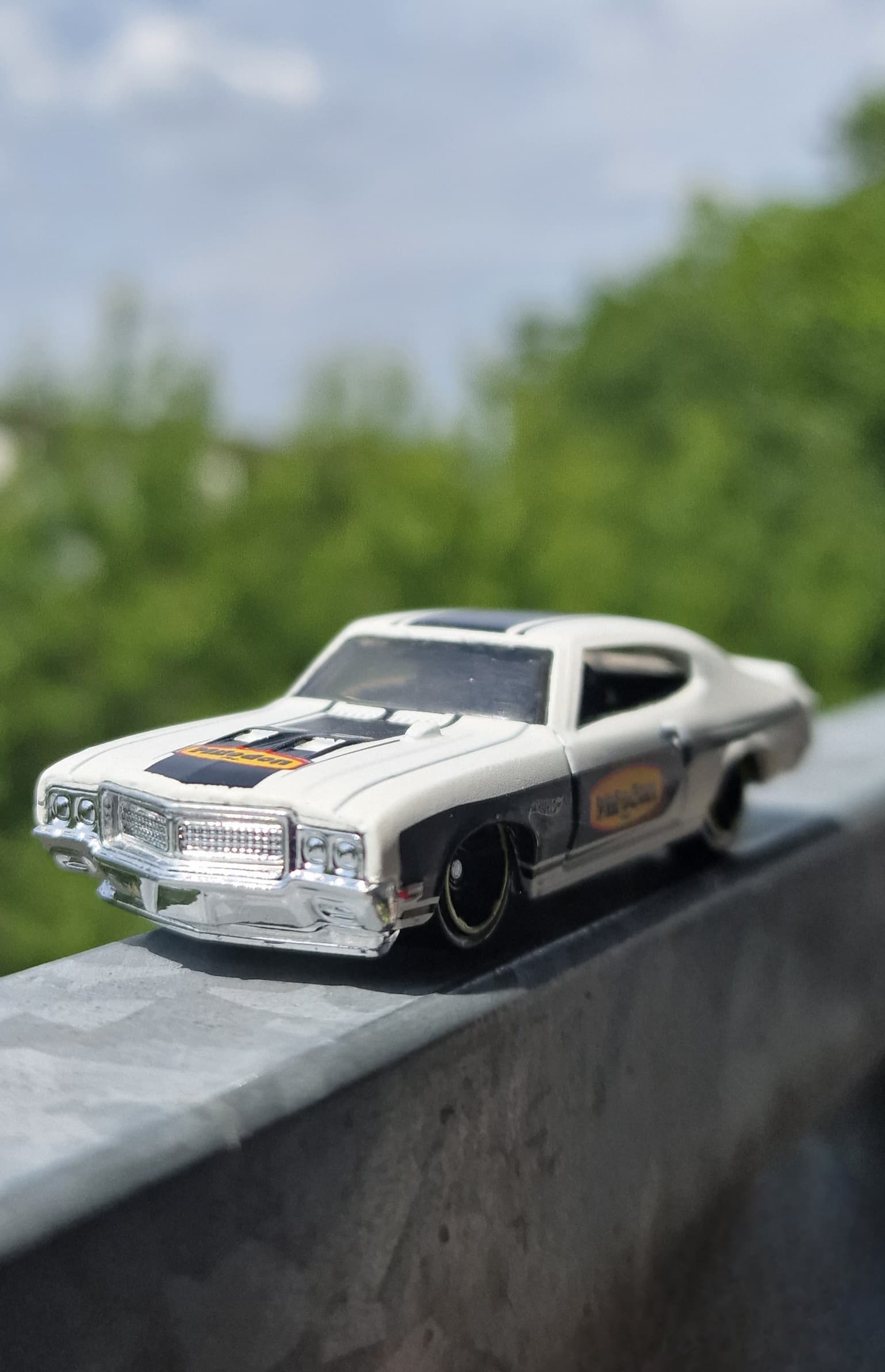 White and chrome Hot Wheels Buick GSX in outdoor light